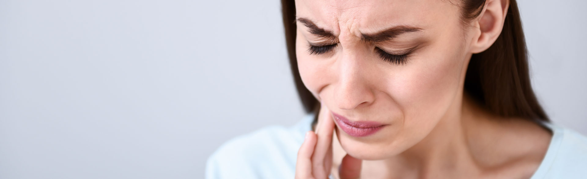 Woman suffering from jaw pain