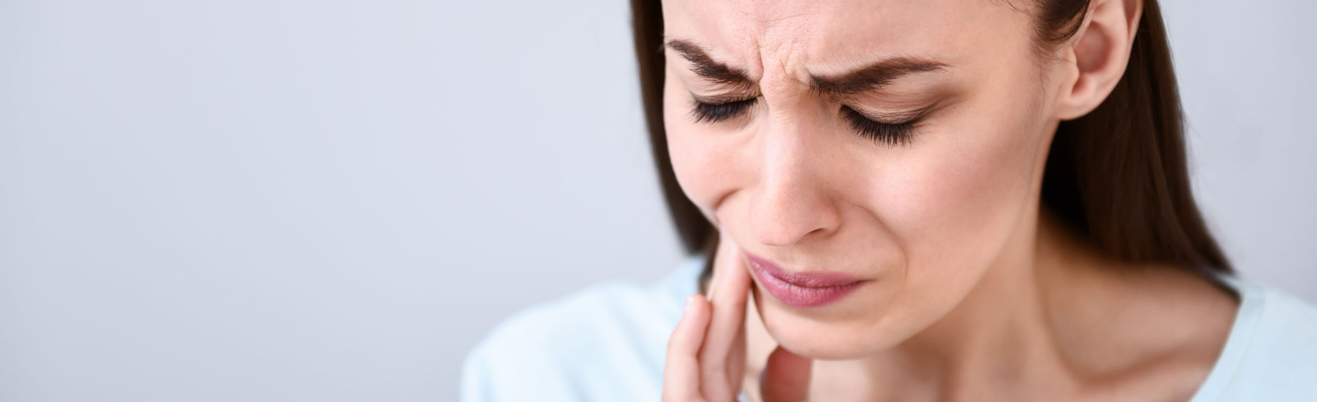 A person clenching their jaw, representing the effects of TMD and available treatments.
