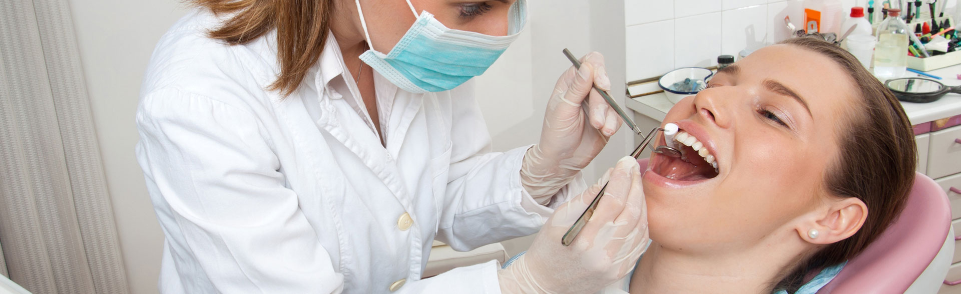 Dentist examining patient teeth before doing bone grafting treatment
