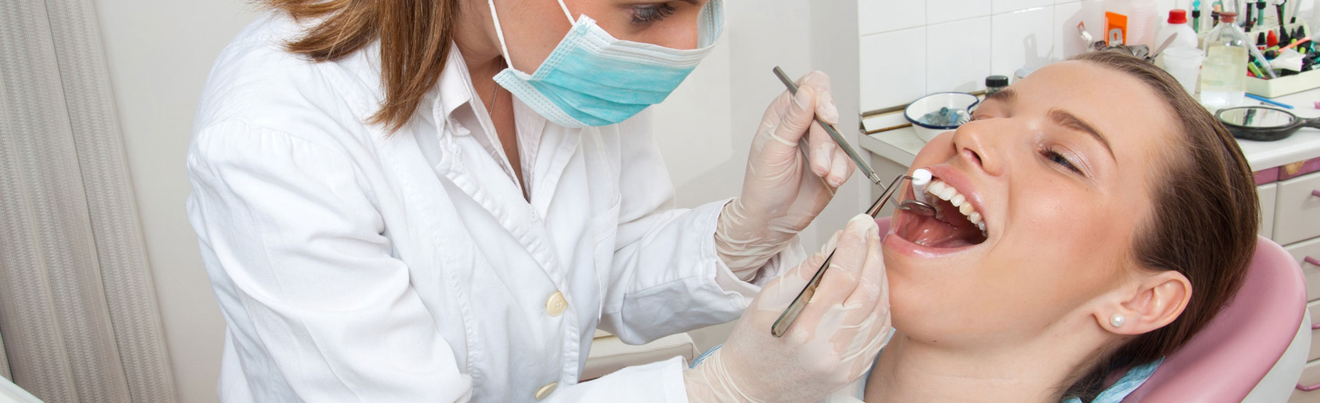 A dentist performing a bone grafting procedure to prepare for dental implants.