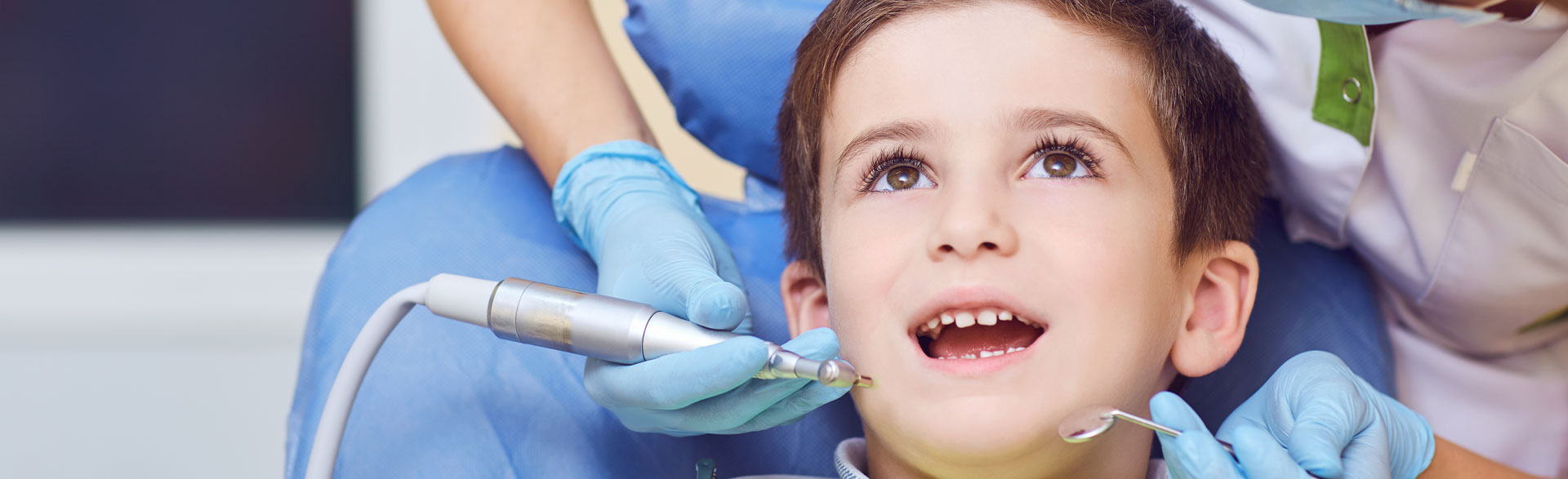 A child with a dentist in a dental office