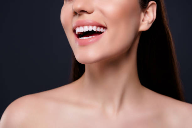 close-up photo of a woman smiling, showing her teeth