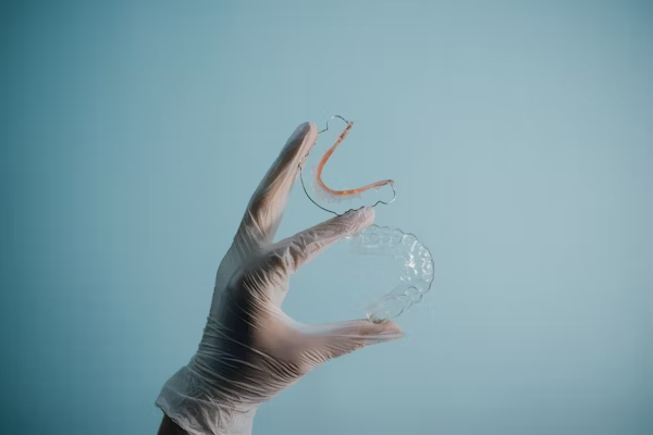 a hand holding up clear night guards