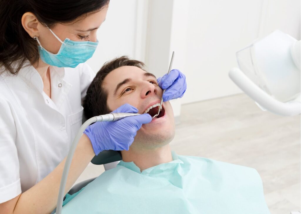 Dentist examining a patient’s gums during a dental checkup to identify gingivitis symptoms and assess overall gum health.