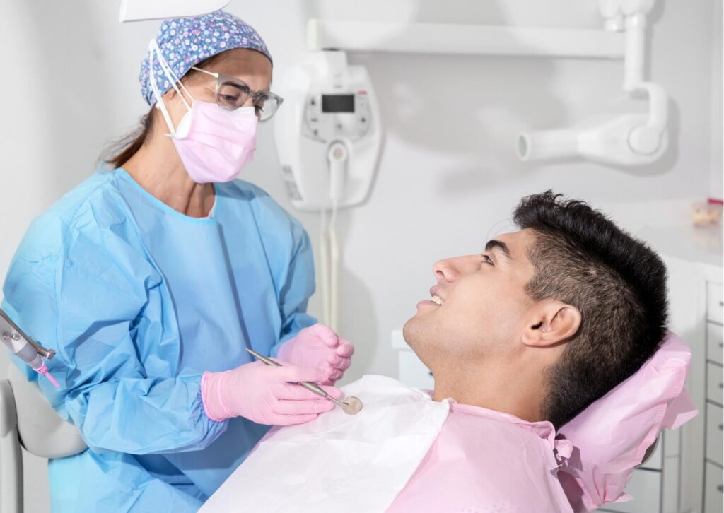 Dentist discussing post-treatment instructions with a patient, including guidance on driving after a root canal treatment.