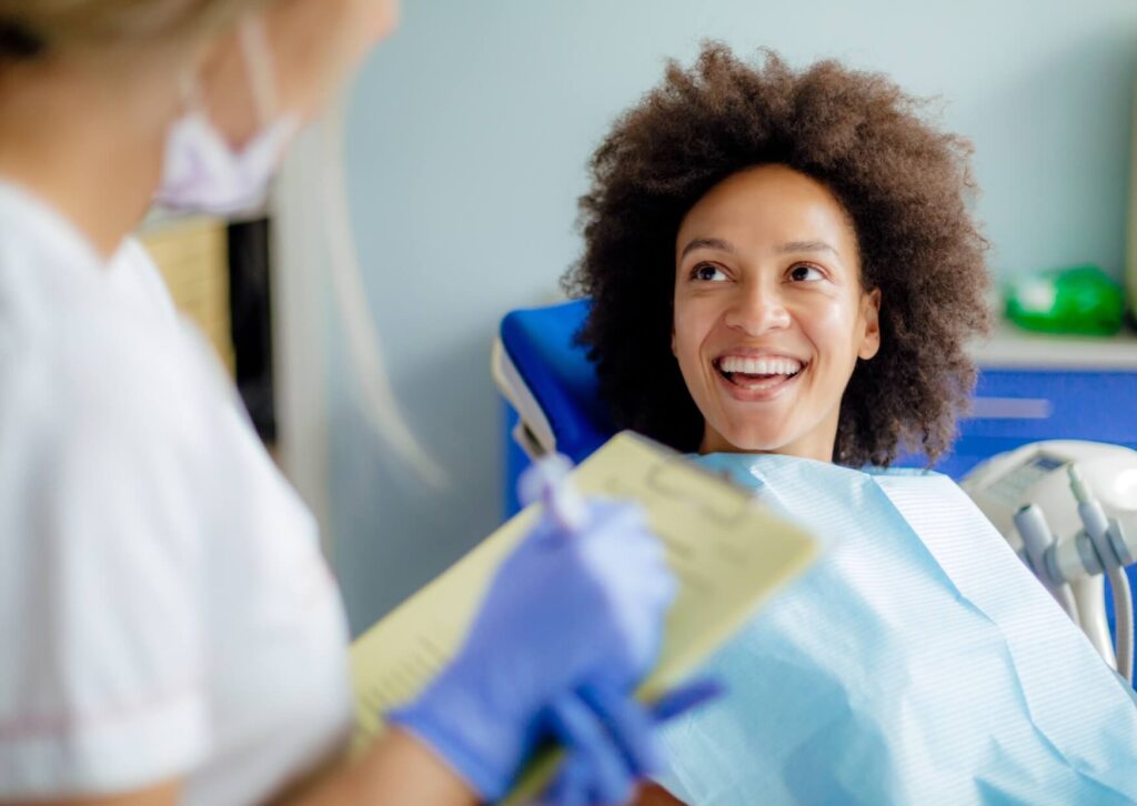 Patient discussing treatment with a dentist before a dental filling procedure, learning how long a tooth filling typically takes.