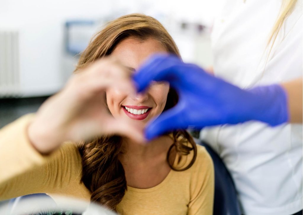 Smiling patient and dental professional celebrating successful gummy smile treatment during a cosmetic dentistry consultation.