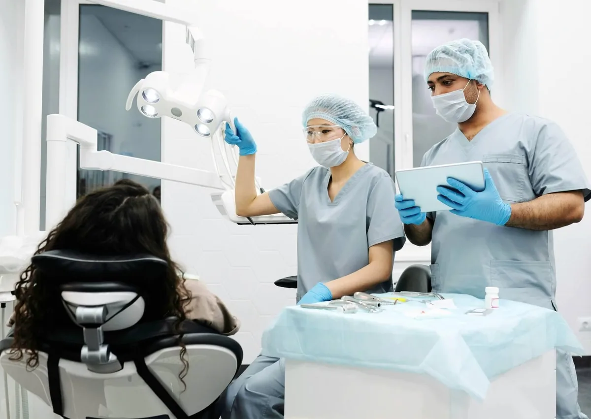 Dental professionals preparing to examine a patient, highlighting post-operative care and dietary recommendations after wisdom teeth removal.